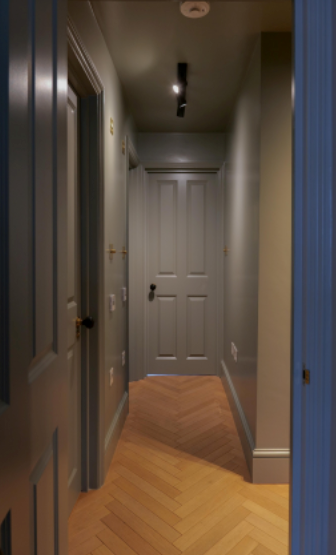 A darker hallway showing the same consistency across the walls, doors and skirting